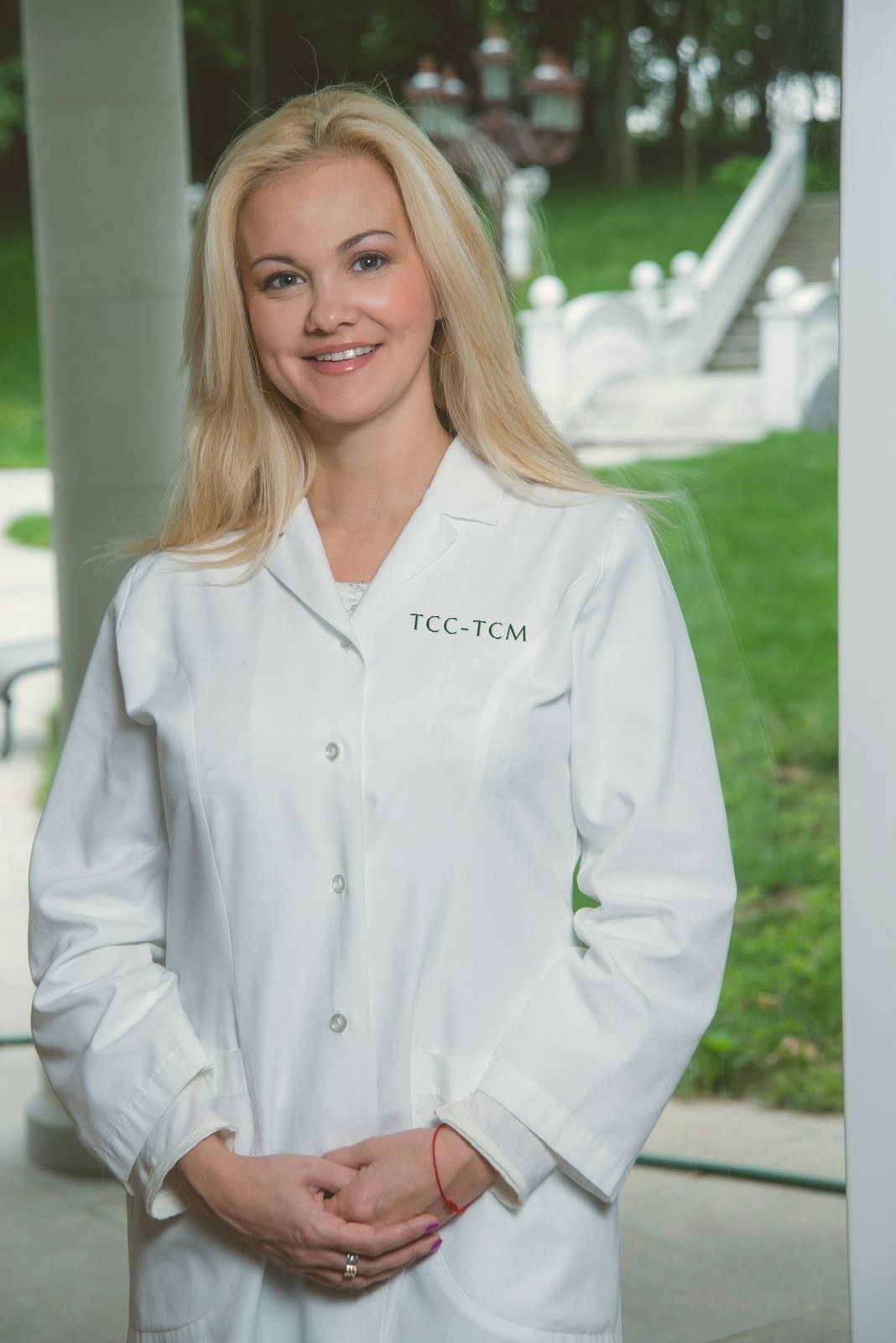 Katherine Chekhter, Registered Acupuncturist and Registered Traditional Chinese Medicine Practitioner, in a white clinical coat